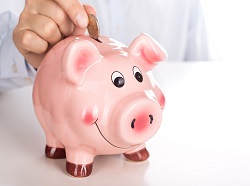 Man's hand putting coin into piggy bank. Save money or investment concept