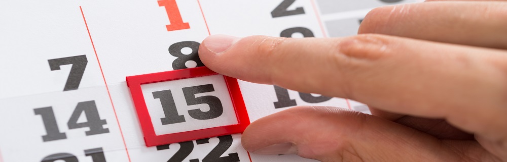 Close-up Of Person Hands Making A Red Mark On Calendar Date